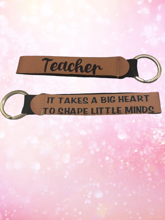 It takes a big heart to shape little minds wristlet